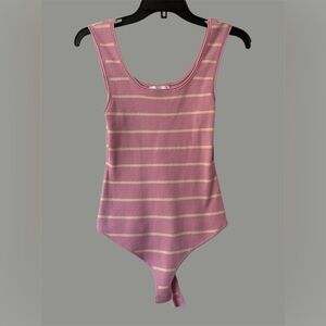 Stile COLLECTION. Charming bodysuit with stripes and a cream color.